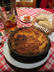 Pastel de Choclo -- Corn Pie made of mashed corn, ground beef, onions, egg, chicken, black olives, and raisins