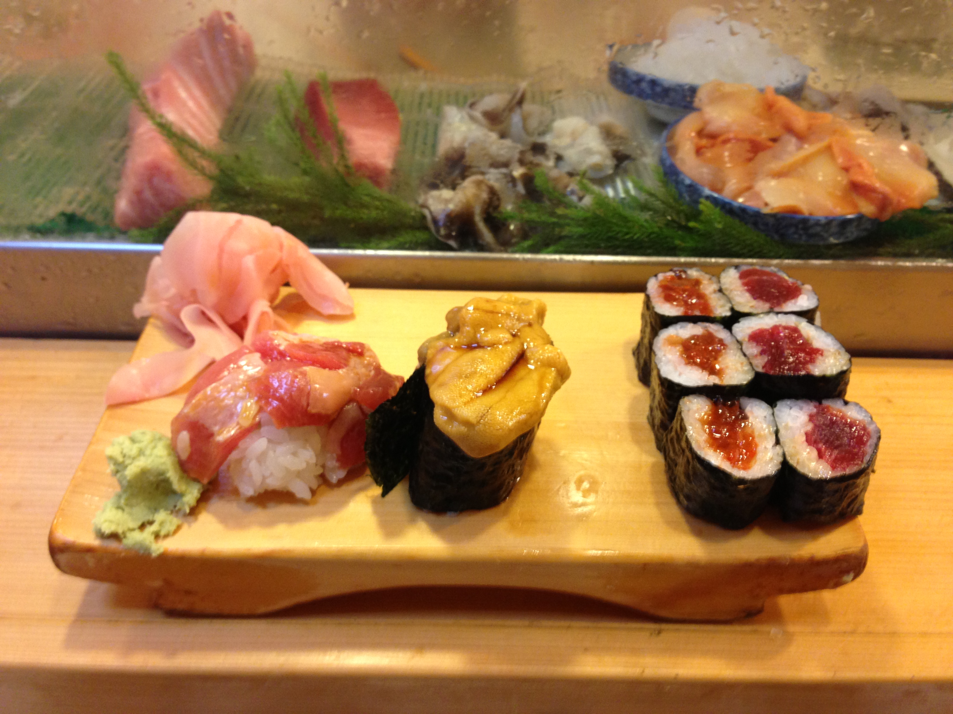 a wooden board with different types of sushi on it