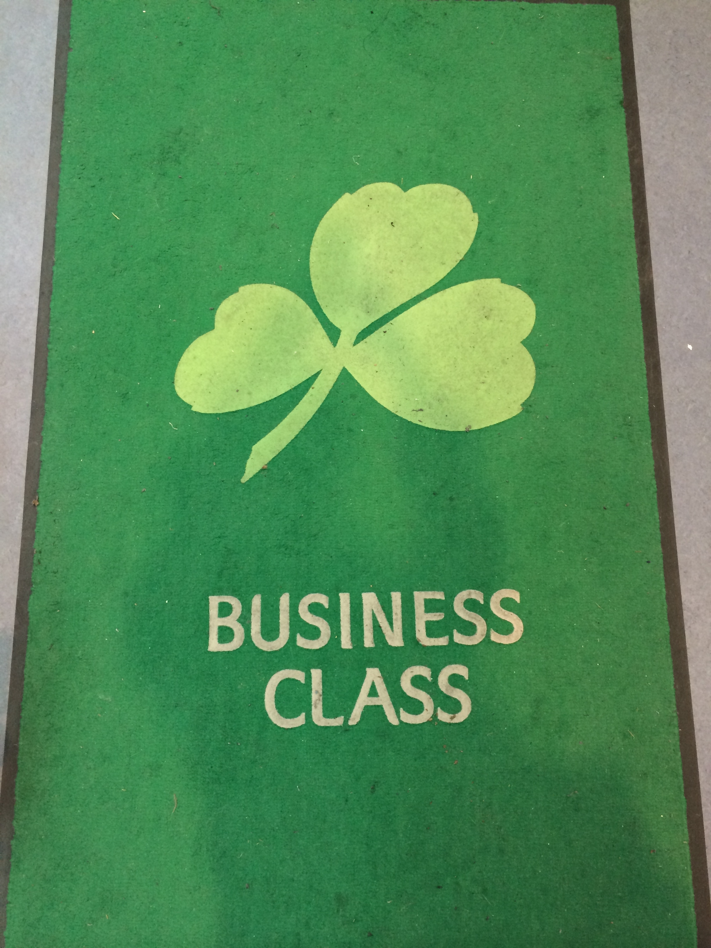a green sign with a clover on it