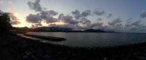 a body of water with a dock and buildings in the distance