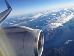 an airplane wing and a body of water