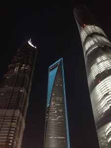 a group of tall buildings at night