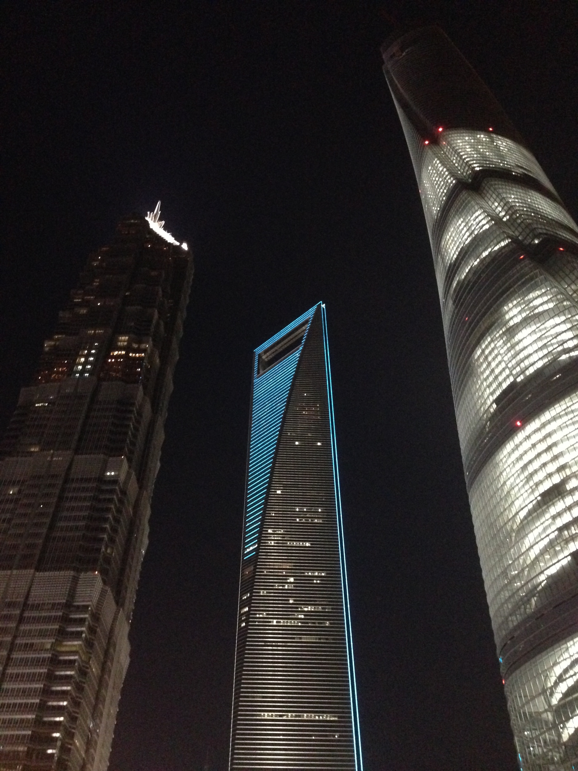 a group of tall buildings at night